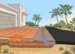 Terracotta pavers transition to asphalt beside palms and a drainage buffer.