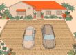 Two cars parked with space between them on a patterned driveway.