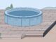 A round hot tub rests on pavers above a compacted base, with the patio sloping away.