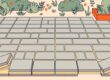 Lifted patio pavers reveal narrow sand-filled joints and a compacted base.