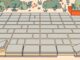 Lifted patio pavers reveal narrow sand-filled joints and a compacted base.